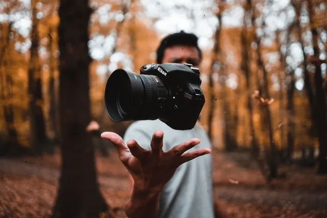 photography guy holding floating camera