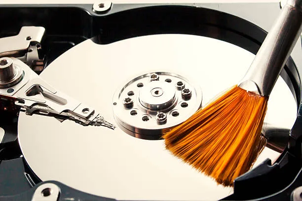 Photo of brush cleaning an opened hard drive