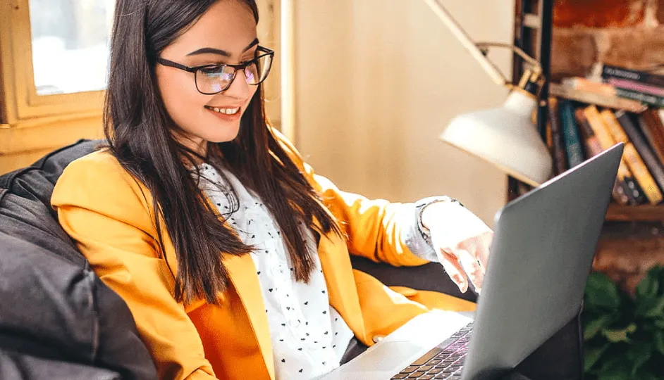 Woman Smiling At Laptop