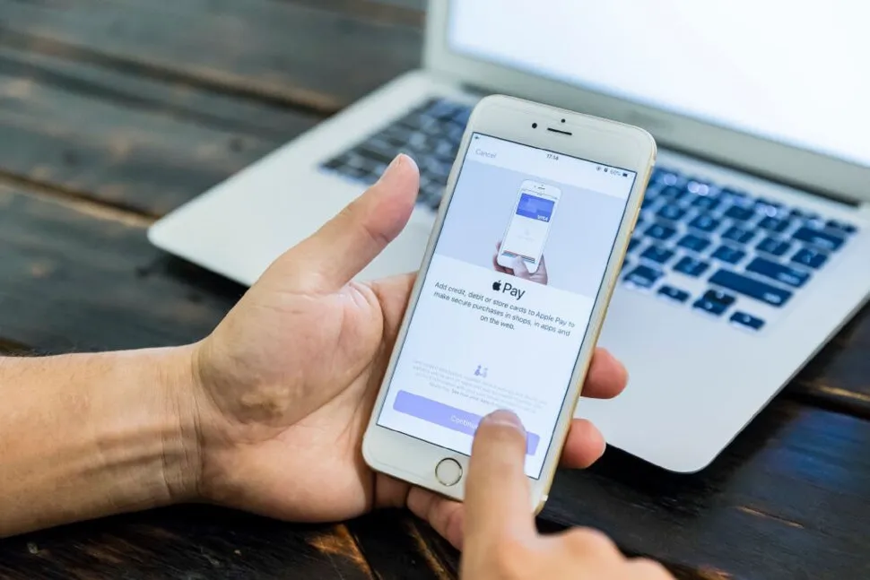 apple pay person's hands using iphone