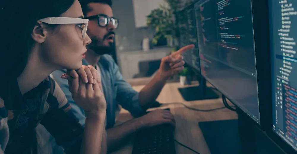 network-engineers-code two people looking at computer monitors